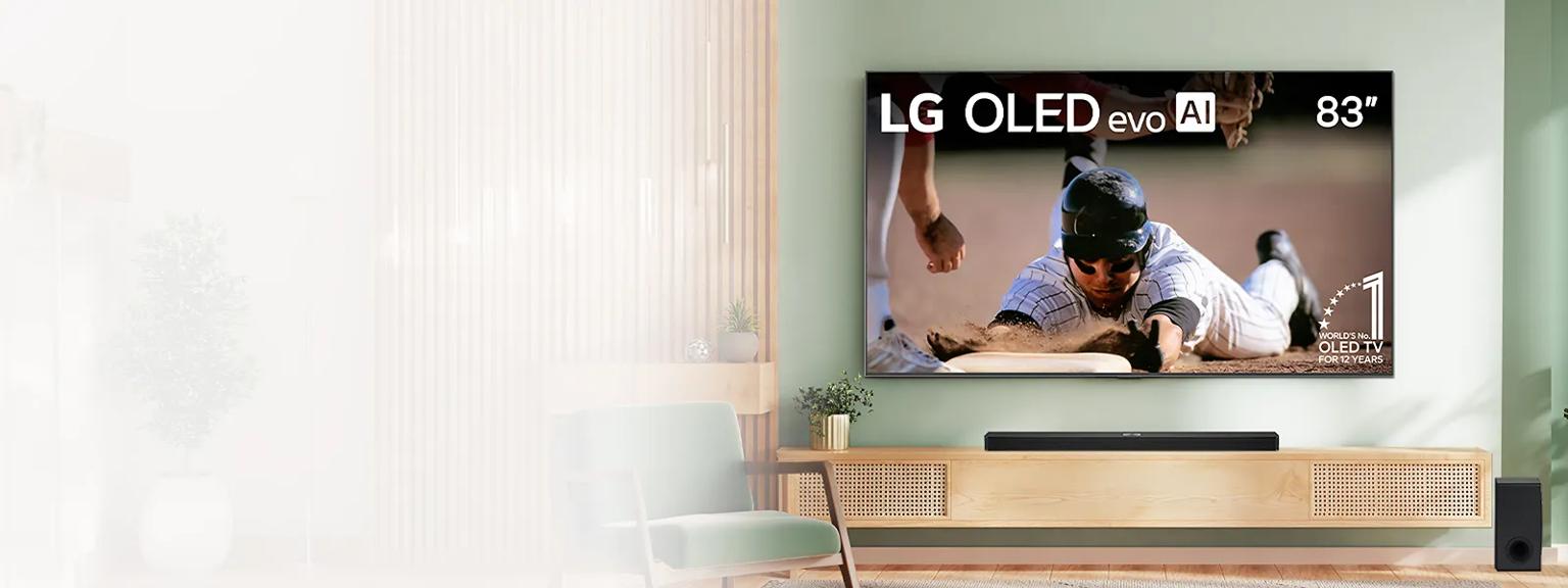 Modern living room with an 83-inch LG OLED evo AI TV displaying a baseball game, mounted on a green wall above a wooden console with a soundbar and speaker.