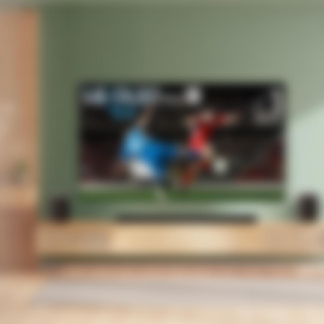 An OLED G6 TV displays a scene from a soccer match in a bright living room setting. “America’s Most Reliable Line of TVs” badge.