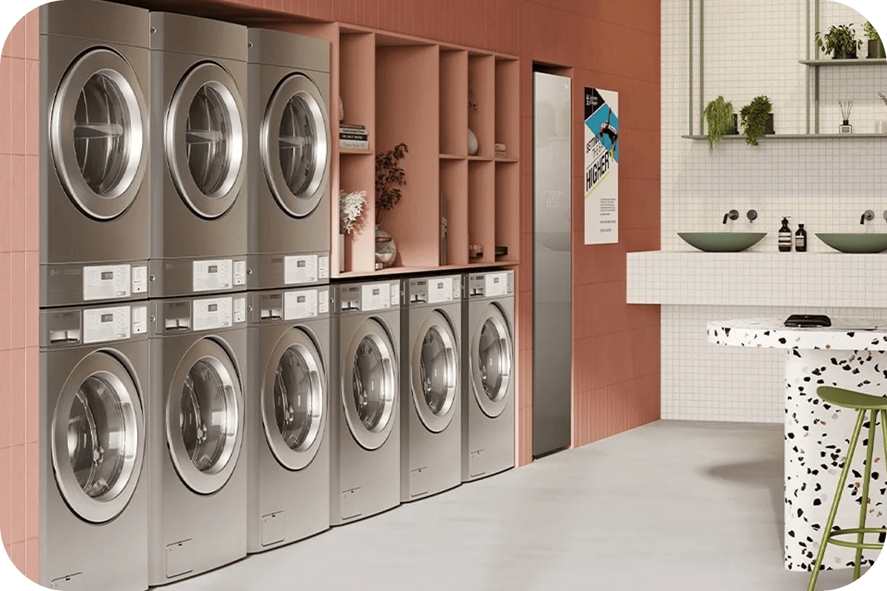 Multiple LG commercial stacked washer and dryer units lined up in a commercial laundry facility.