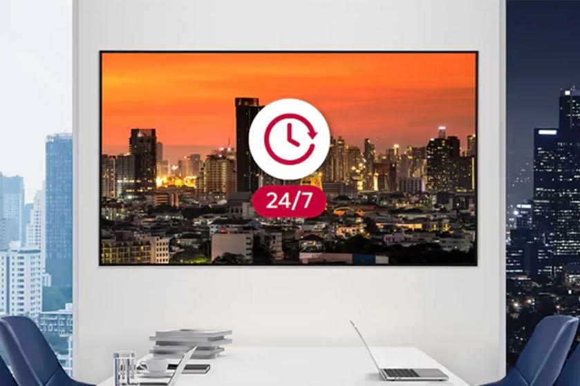 65UL5Q-M UHD Signage in an office conference room, with the two windows showing day and night to represent time passing.