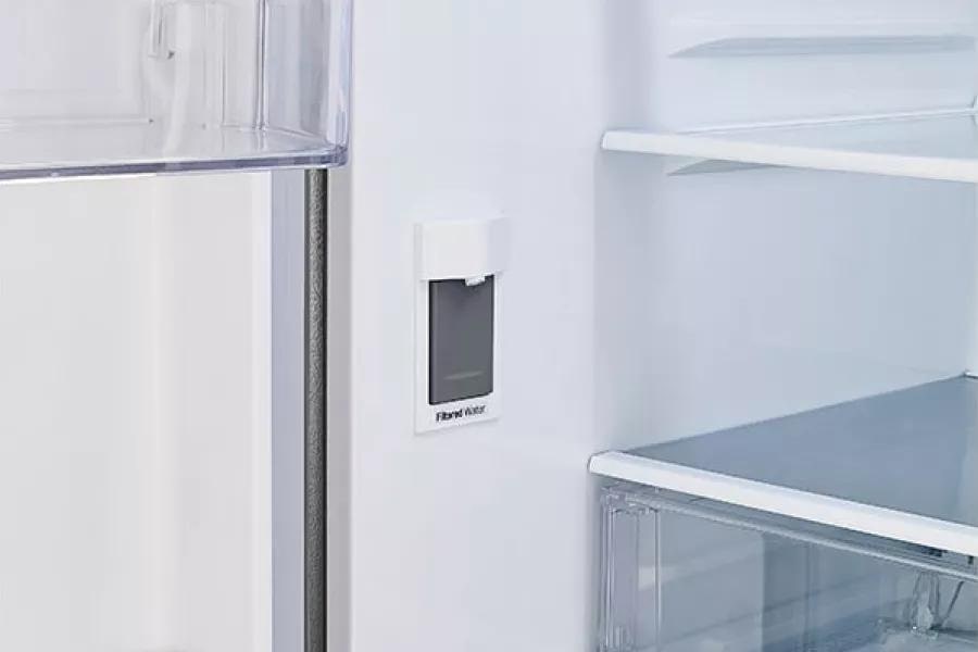 Refrigerator interior showcasing internal water dispenser