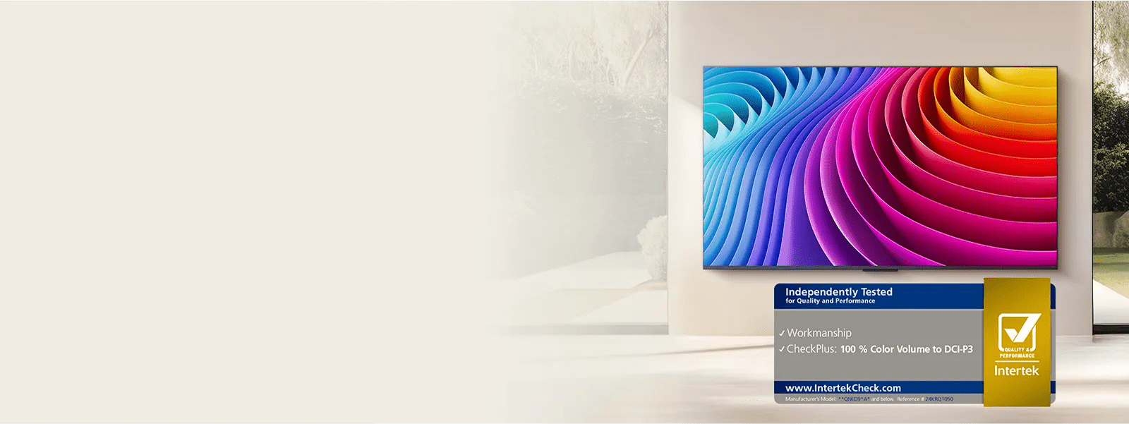 Wall-mounted LG TV with a bright rainbow abstract design and an Intertek certification badge for 100% Color Volume to DCI-P3.