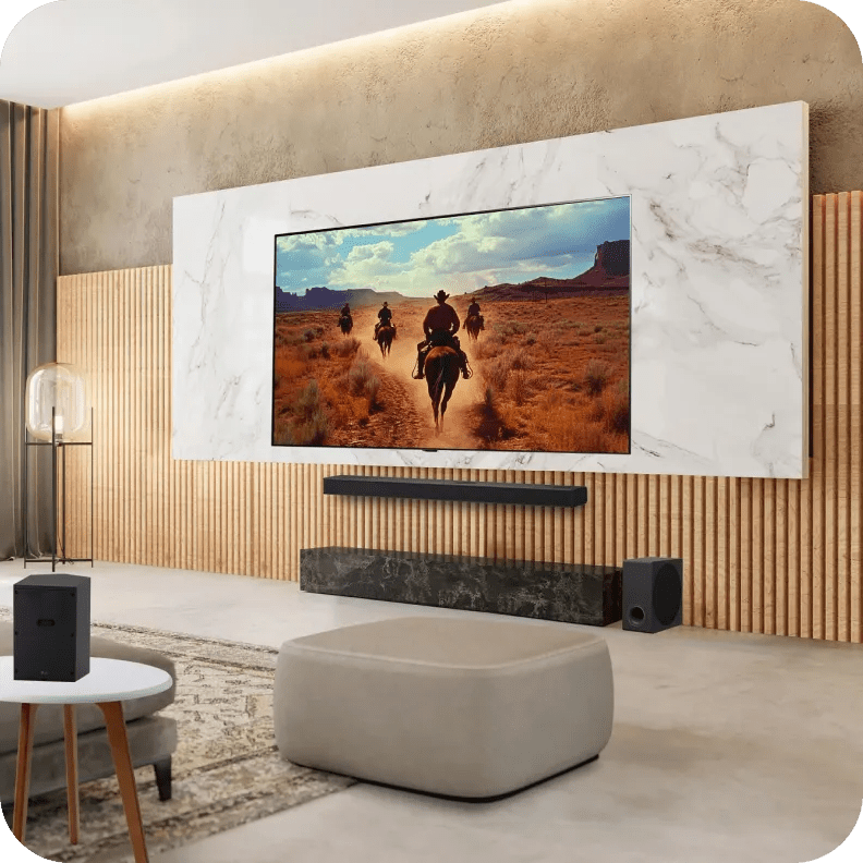 LG TV setup with LG soundbar, subwoofer, and rear speakers in a cozy living room with ambient lighting.