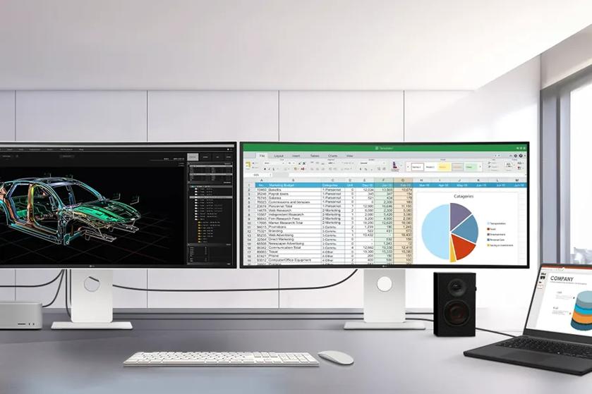Two large computer monitors on a desk showing a 3D car model and a spreadsheet with a pie chart.