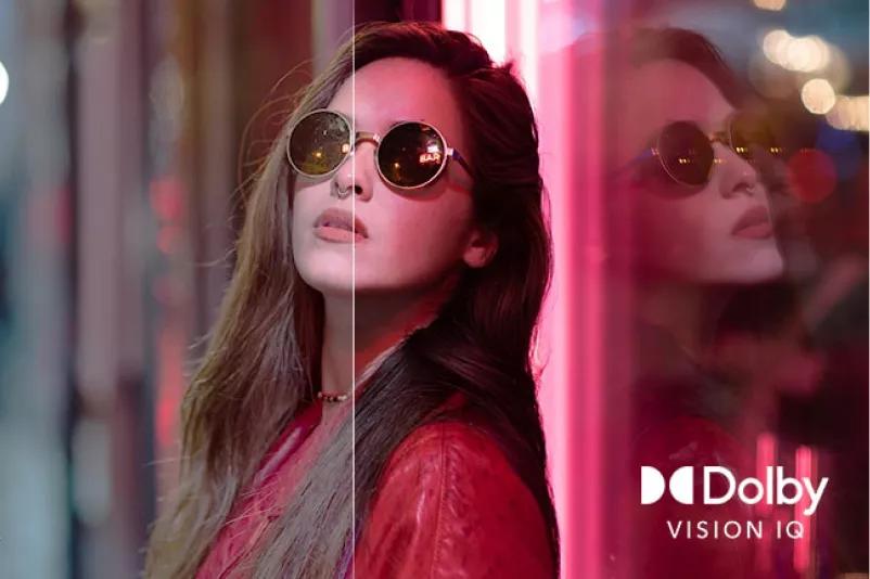 A scene of a woman wearing sunglasses is divided into two for visual comparison On the image there are text of SDR on the bottom left and Dolby Vision IQ logo on the bottom right