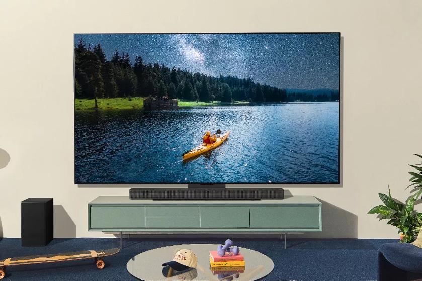 A TV in the living room shows an image of a person canoeing. 