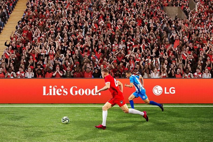 Soccer players in a stadium with a cheering crowd and an "LG" advertisement.