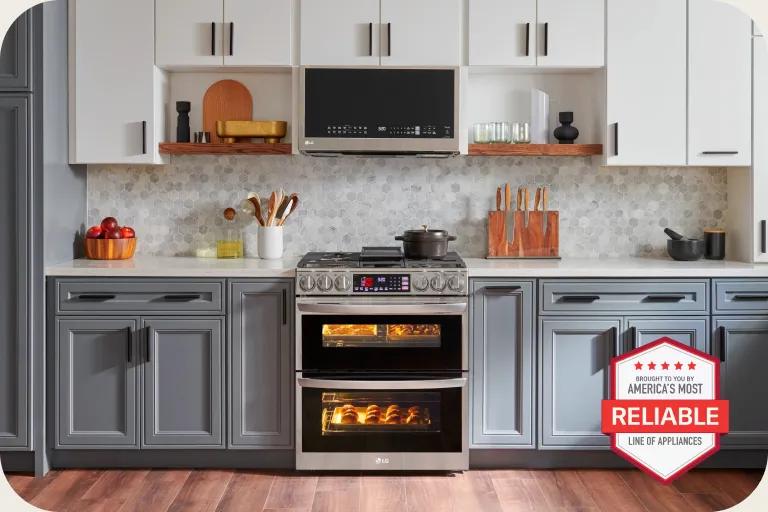 LG kitchen featuring a double oven range with illuminated interiors, gray and white cabinetry, tiled backsplash and warm wood accents, with a badge that says, "Brought to you by America's Most Reliable Line of Appliances."