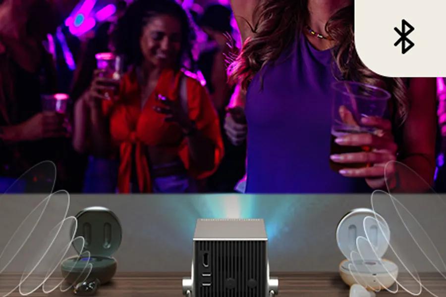 PU600U Projector with Bluetooth connectivity streaming audio to wireless earbuds in party setting
