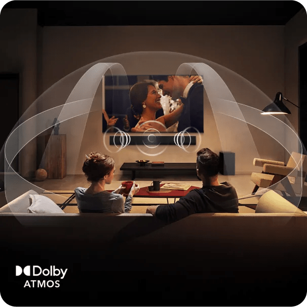 Couple relaxing on sofa watching romantic movie on LG TV with Dolby Atmos visual showing immersive surround sound waves.