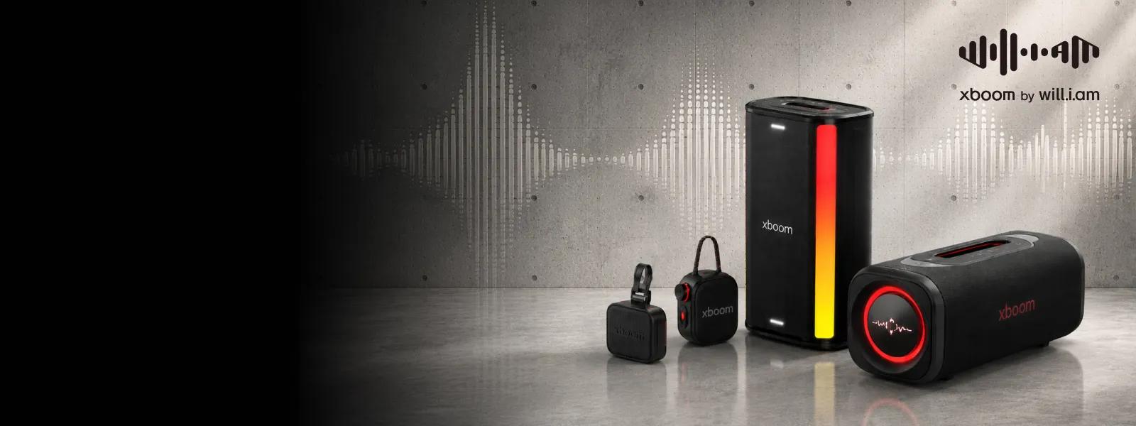 LG xboom speaker lineup designed with will.i.am, featuring four portable speakers with red and orange lighting effects against a concrete wall backdrop, with sound wave graphics and xboom by will.i.am logo visible in the upper right corner