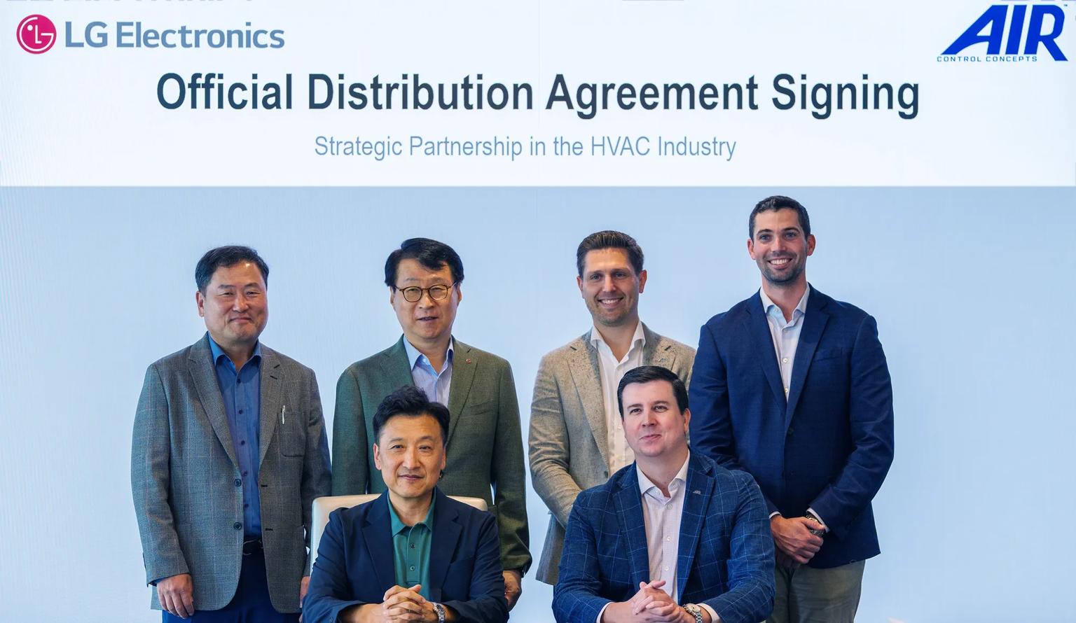 LG Electronics and Air Control Concepts executives pose together in front of a banner marking their Official Distribution Agreement Signing for a strategic HVAC industry partnership.