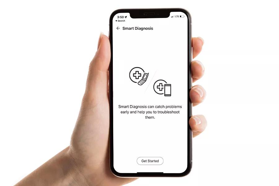 Hand holding phone showing Smart Diagnosis feature in app on the screen