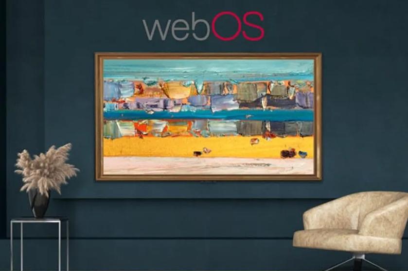 An LG OLED TV that looks like a framed landscape painting beneath the "webOS" logo on a dark-colored wall.