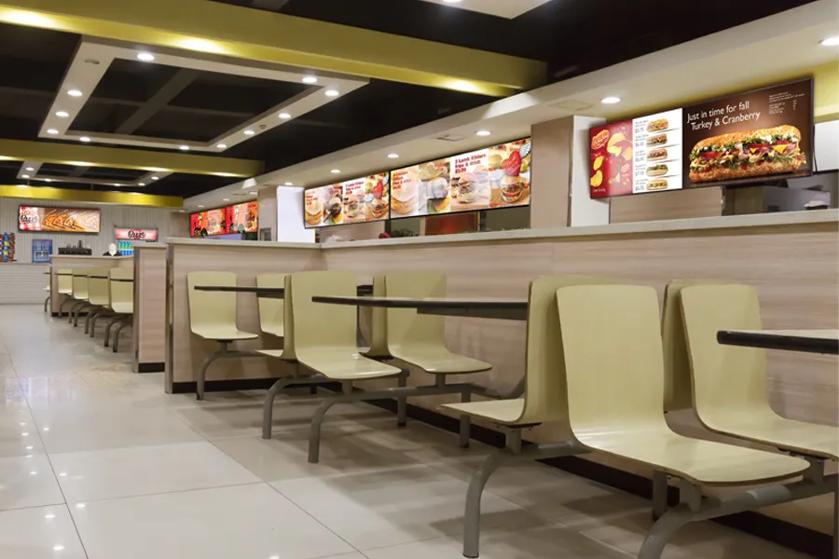 An interior of a quick serve restaurant, with LG displays being used as dynamic menu boards. 