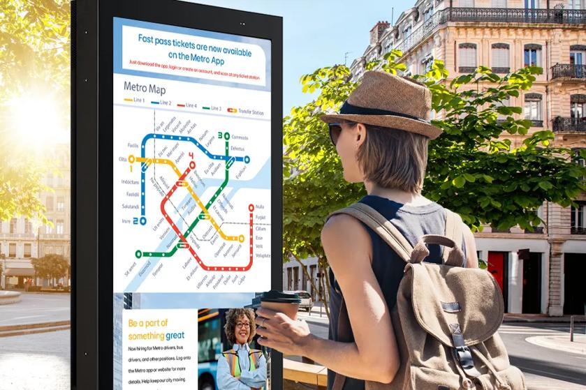 A woman looks at the 75XE3C outdoor display. She's able to see the map displayed on it despite her polarized sunglasses thanks to the quarter wave plate.