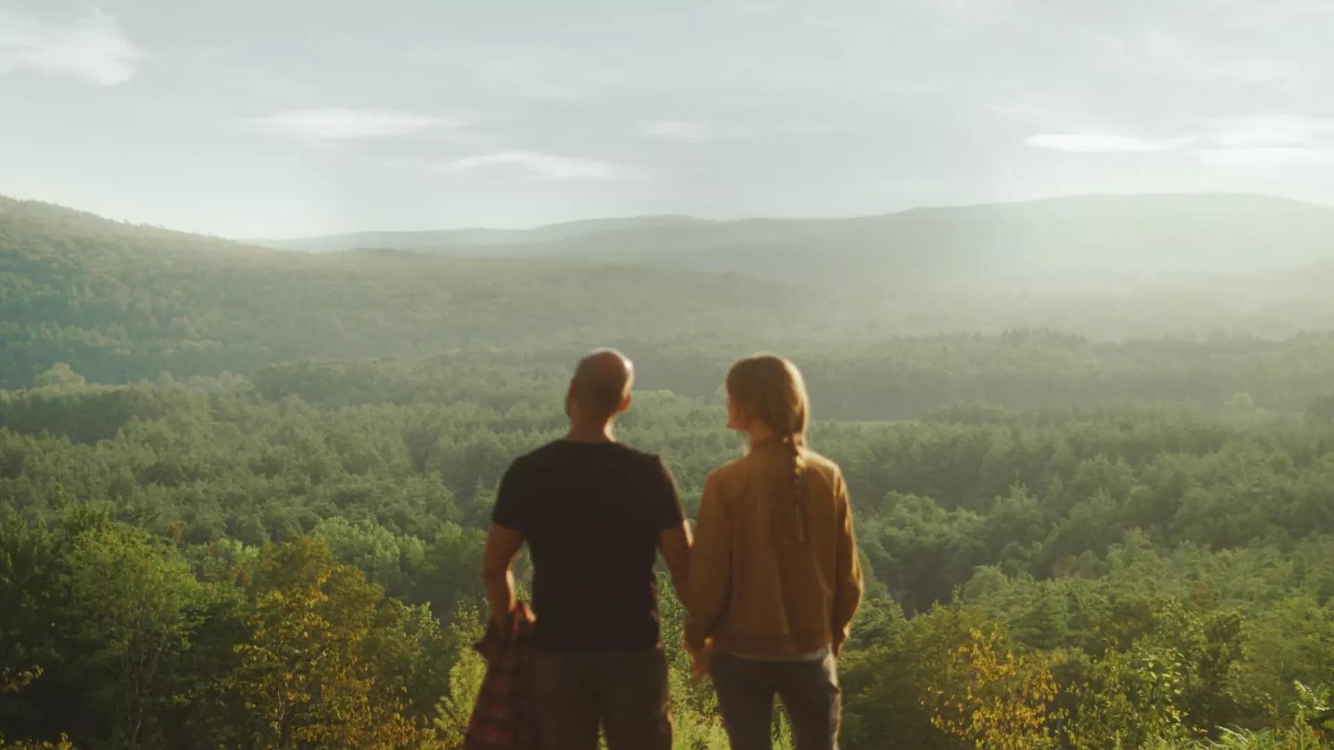 Couple facing a field.