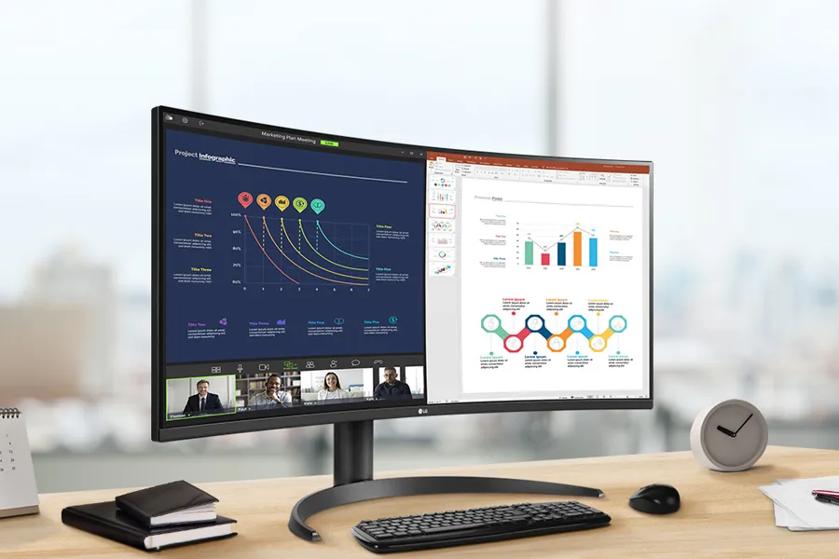 A modern home office setup featuring a large ultra-wide LG monitor displaying data dashboards, 3D graphics, and project management tools, with a wireless keyboard and mouse on a wooden desk.