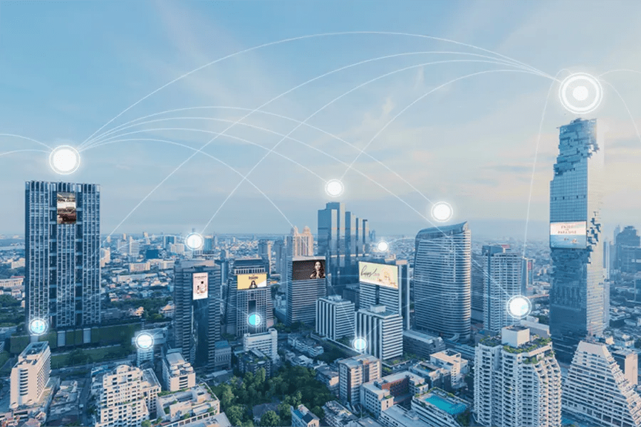 Modern city skyline with digital network connections illustrated by glowing circles and lines.