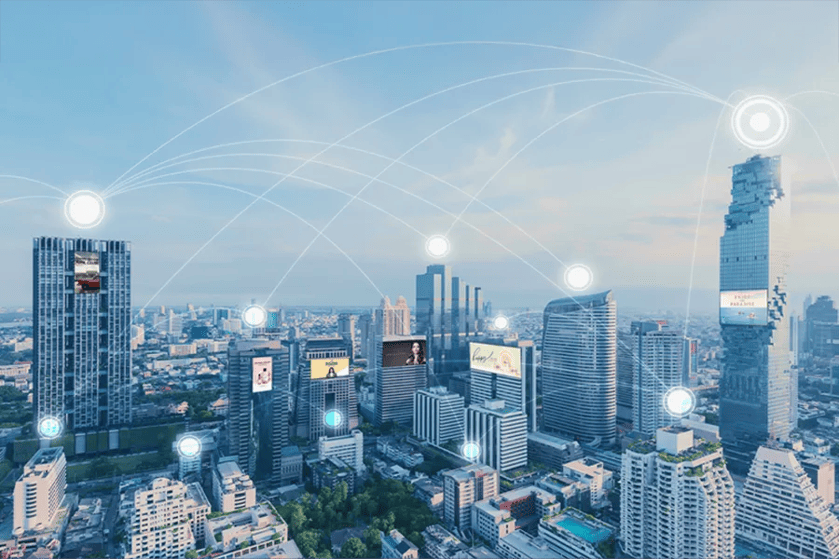 Modern city skyline with digital network connections illustrated by glowing circles and lines.