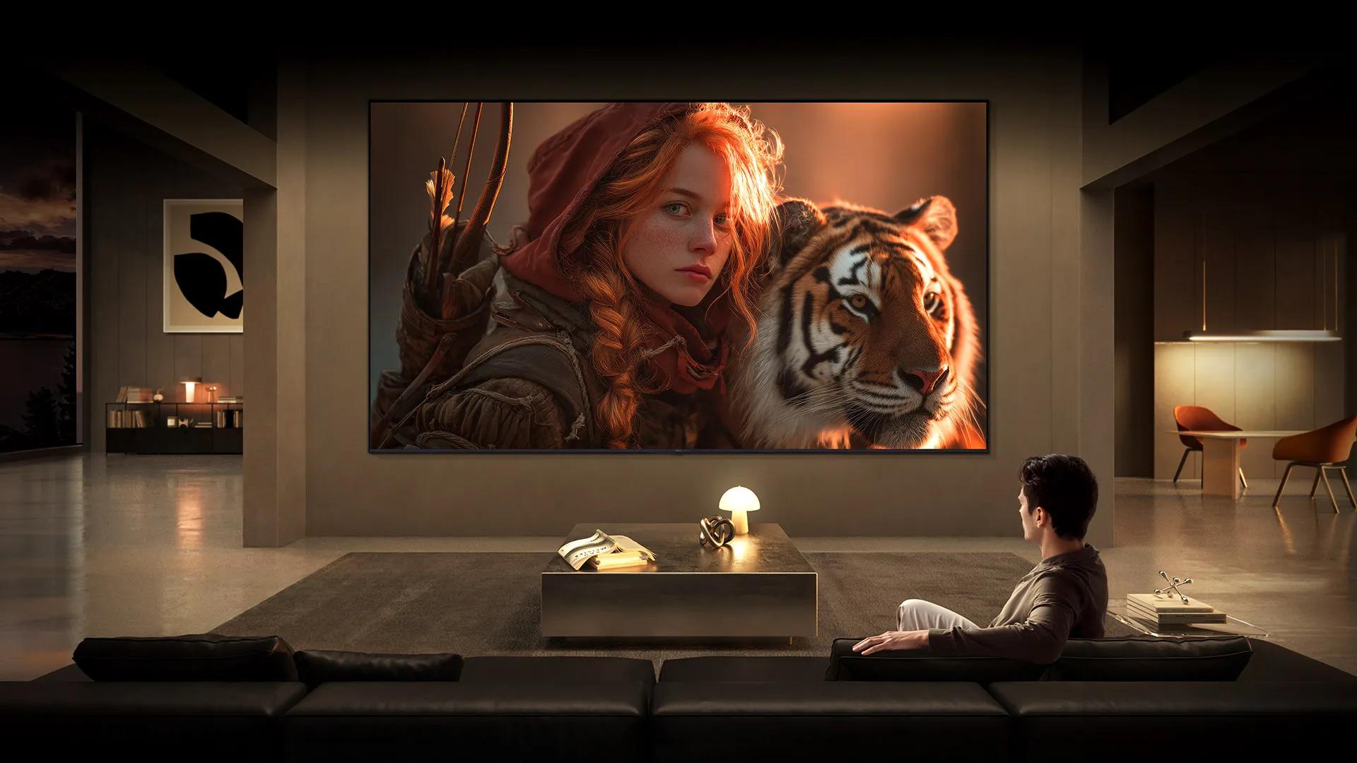 LG TV for watching movies fills a modern living room with a cinematic scene on a large wall-mounted display, featuring a detailed close-up of a character and tiger, highlighting rich color depth, strong contrast, and immersive viewing.