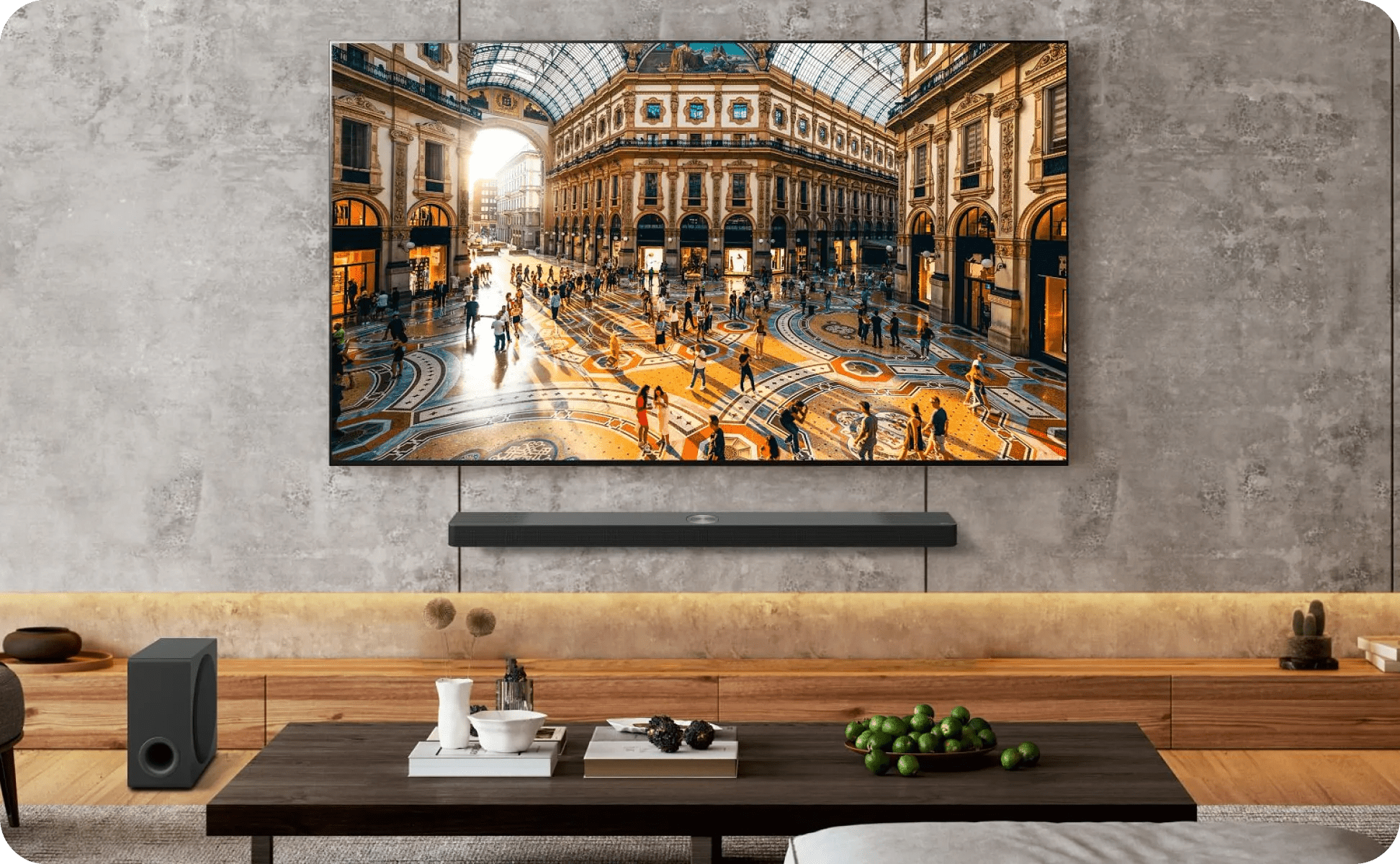 A modern living room with concrete wall and wood table, with an LG TV displaying an indoor plaza, and LG soundbar and subwoofer below.
