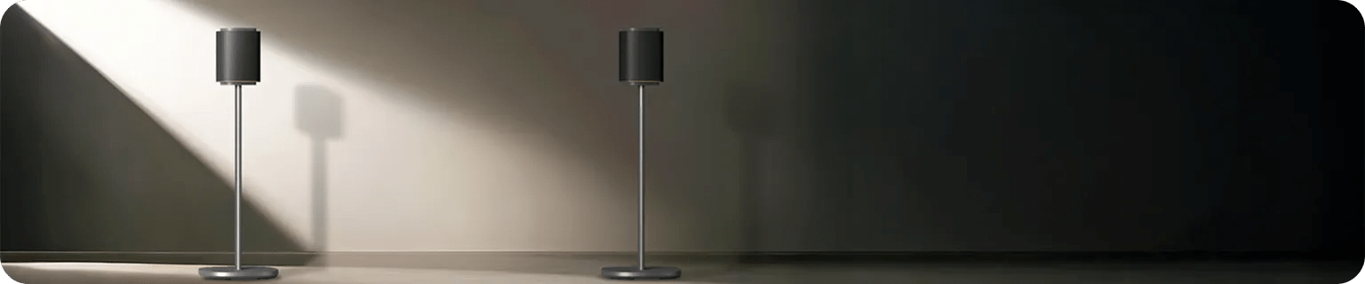 Two sleek speaker stands for LG M7 and M5 speakers against a softly lit wall.