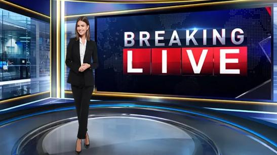 A newscaster stands in front of an LG Direct View LED backdrop with a Breaking News graphic. 