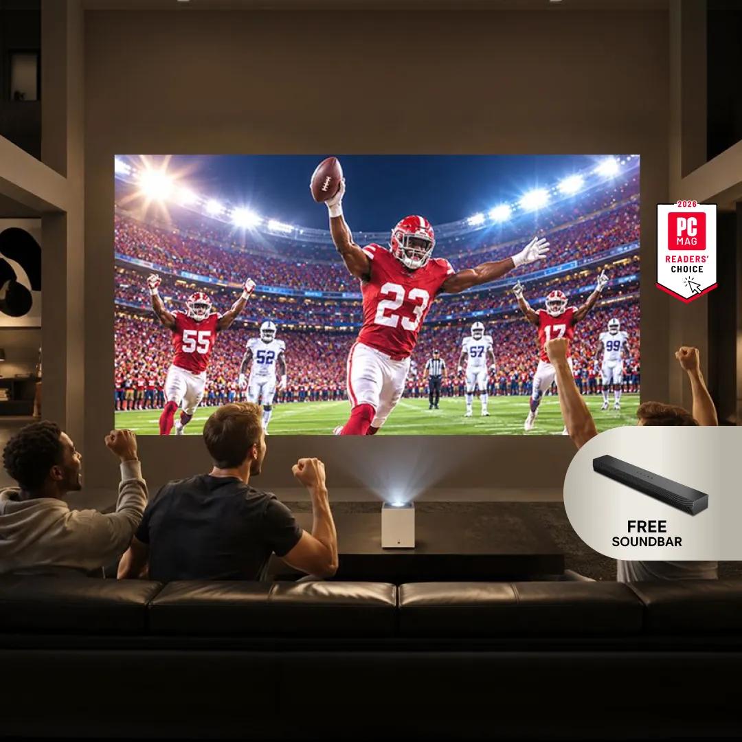 Three friends on a couch cheering while watching a football touchdown on a large LG projector screen, with a PC Mag Readers' Choice badge and a 'Free Soundbar' offer badge.