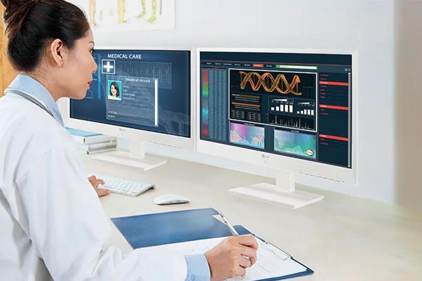 A doctor at a desk using an LG all-in-one cloud thin client.