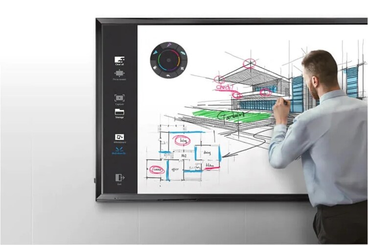 a person writing on an LG Commercial Display monitor on the wall