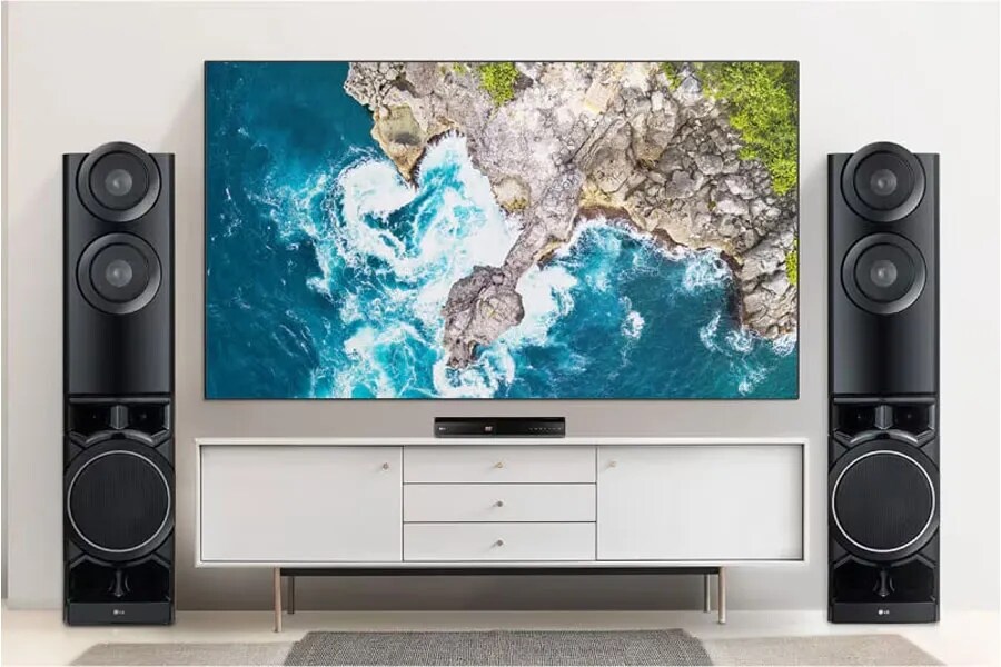 an entertainment center with a top-view image of the ocean on the TV screen