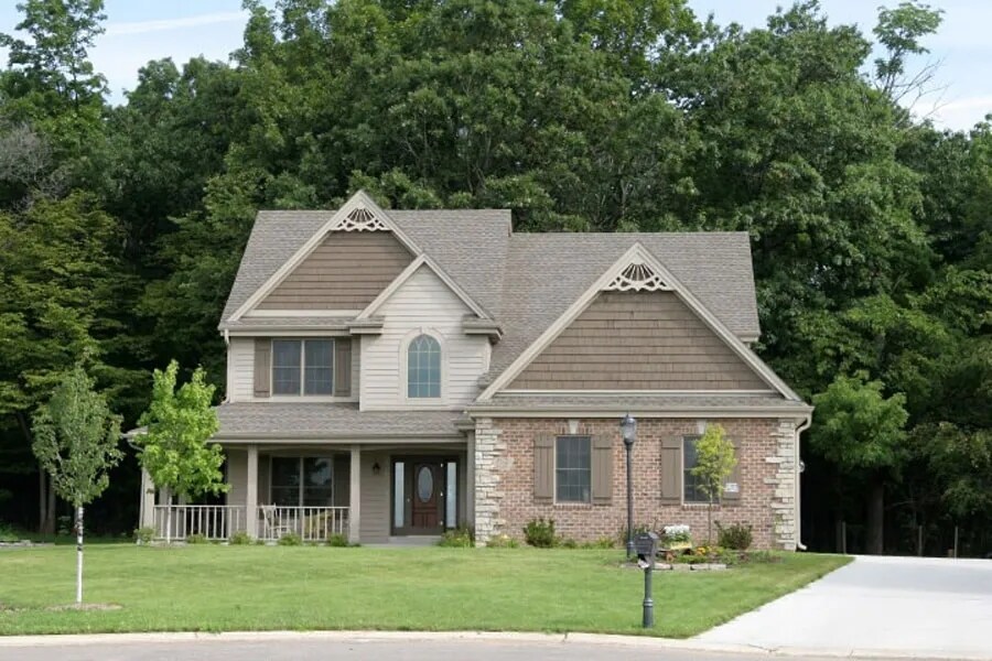 Image of a Single Family home, front view showing a driveway and yard.