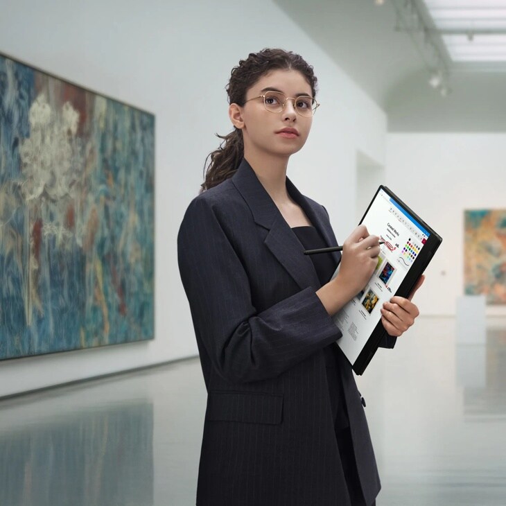 LG Gram 16T95TP-K.AA77U1 laptop in tablet mode with stylus being used in art gallery setting - Lifestyle
