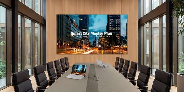 Modern conference room with a large screen displaying "Smart City Master Plan" and urban scene.
