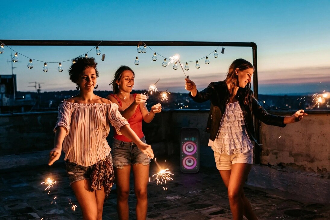 People dancing at night around the xboom XL9T speaker