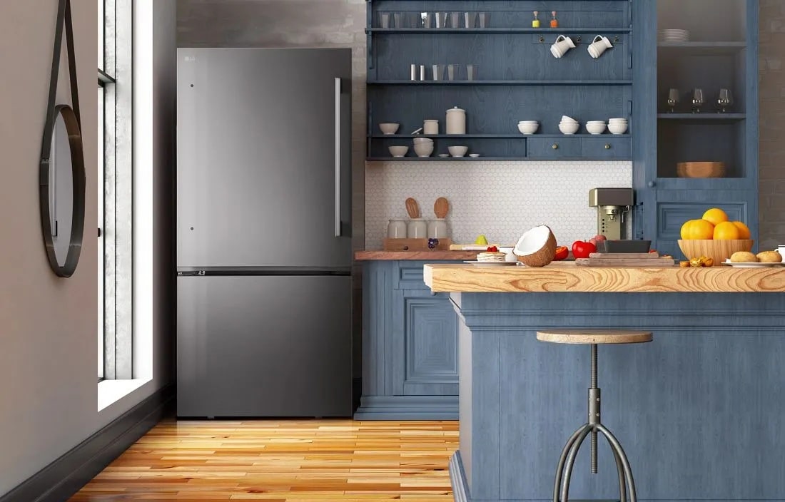 LG LB26H2200D Bottom Freezer Refrigerator in stainless steel finish integrated in modern blue kitchen with wooden countertop - Lifestyle Kitchen Setting