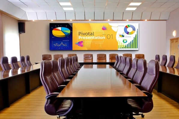 Modern conference room with a U-shaped table and digital screen displaying a presentation.