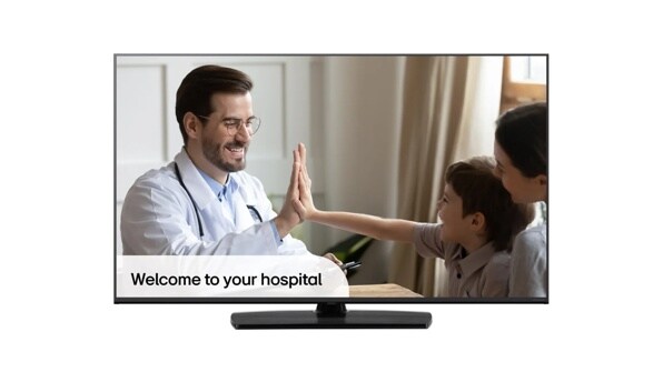 Doctor giving a high-five to a young boy next to a woman, displayed on a TV screen.