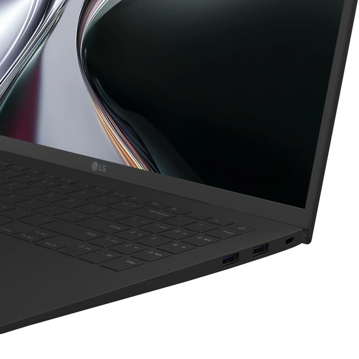 LG Gram 15Z95U-H.AU87U1 Laptop showing keyboard, USB ports, and partial display with abstract design - Side Angle