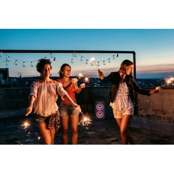 People dancing at night around the xboom XL9T speaker