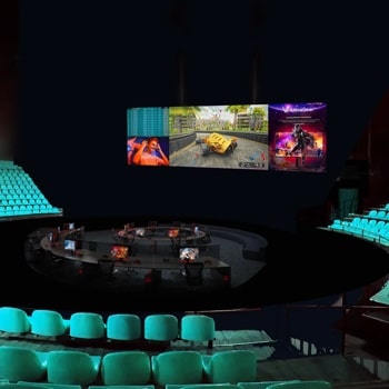 A dimly lit esports arena with teal seating and a central gaming area under a large screen displaying a video game.1