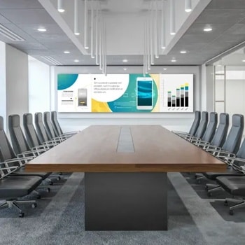 Modern conference room with a long table, surrounded by chairs, a large screen, and a window view of skyscrapers.1