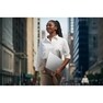 A business woman walks through the city holding 16Z90U-K gram laptop