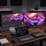 LG 32U990A-S and 32UP83AK-W monitors in dual-screen creative workspace setup with video editing software