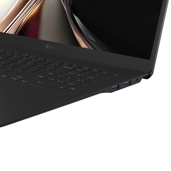 LG Gram 17Z90U-G.AU75U1 Laptop showing keyboard corner with USB ports and colorful display background - Side Angle