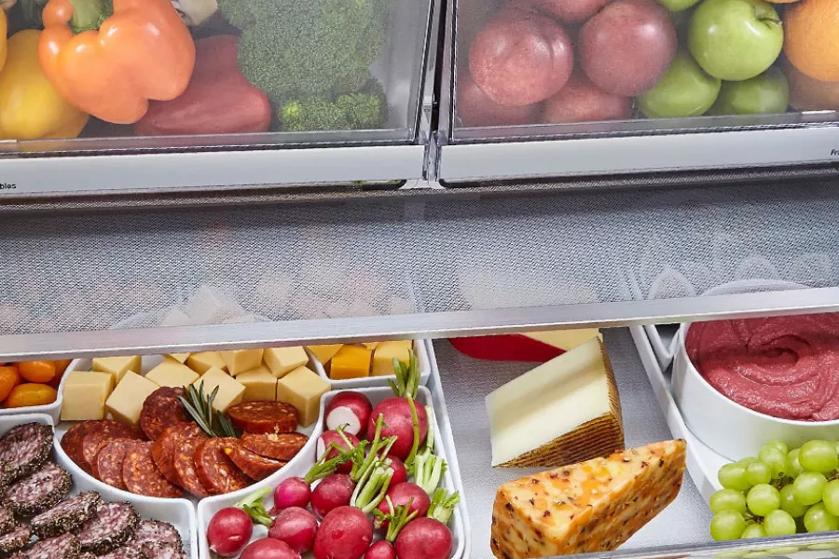 closeup of open refrigerator full of food