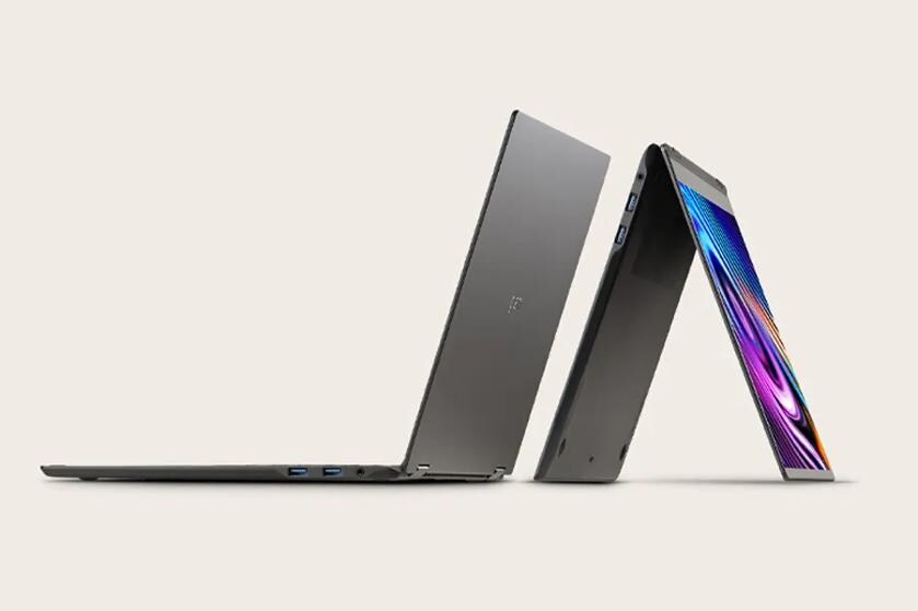 Two sleek laptops partially open, one showing vibrant display colors.