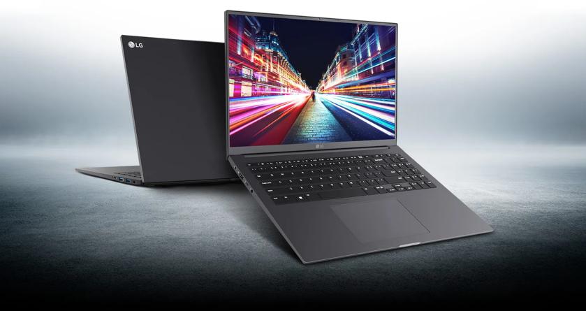 An open LG laptop with a sleek black design is displayed on a reflective surface. The screen shows a vibrant cityscape with colorful light trails, emphasizing its high-resolution display. The back of the laptop is visible in the background, showcasing the minimalist LG logo. The overall composition highlights the laptop's lightweight and modern aesthetic.
