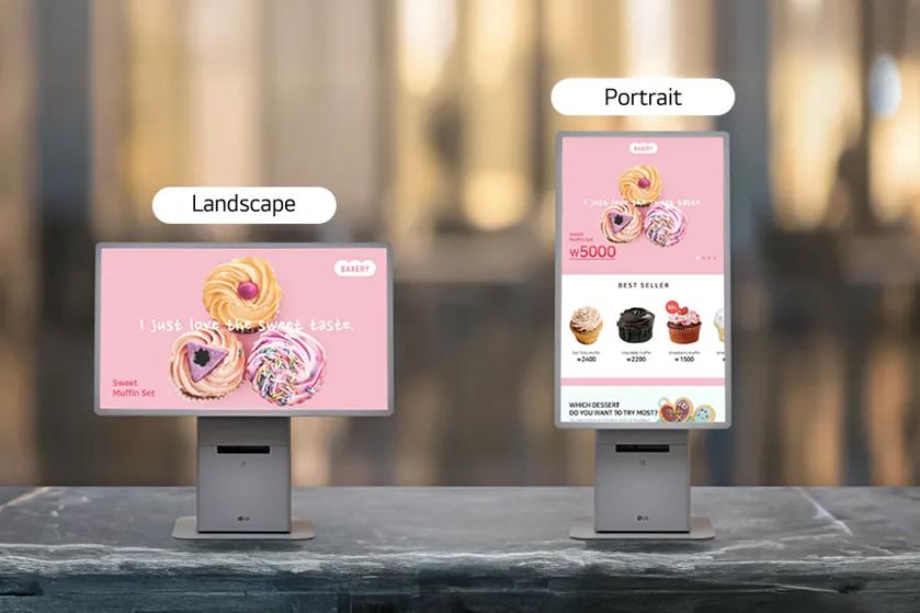 Two digital displays on a marble surface, one in landscape orientation and one in portrait mode, showing bakery-themed visuals.